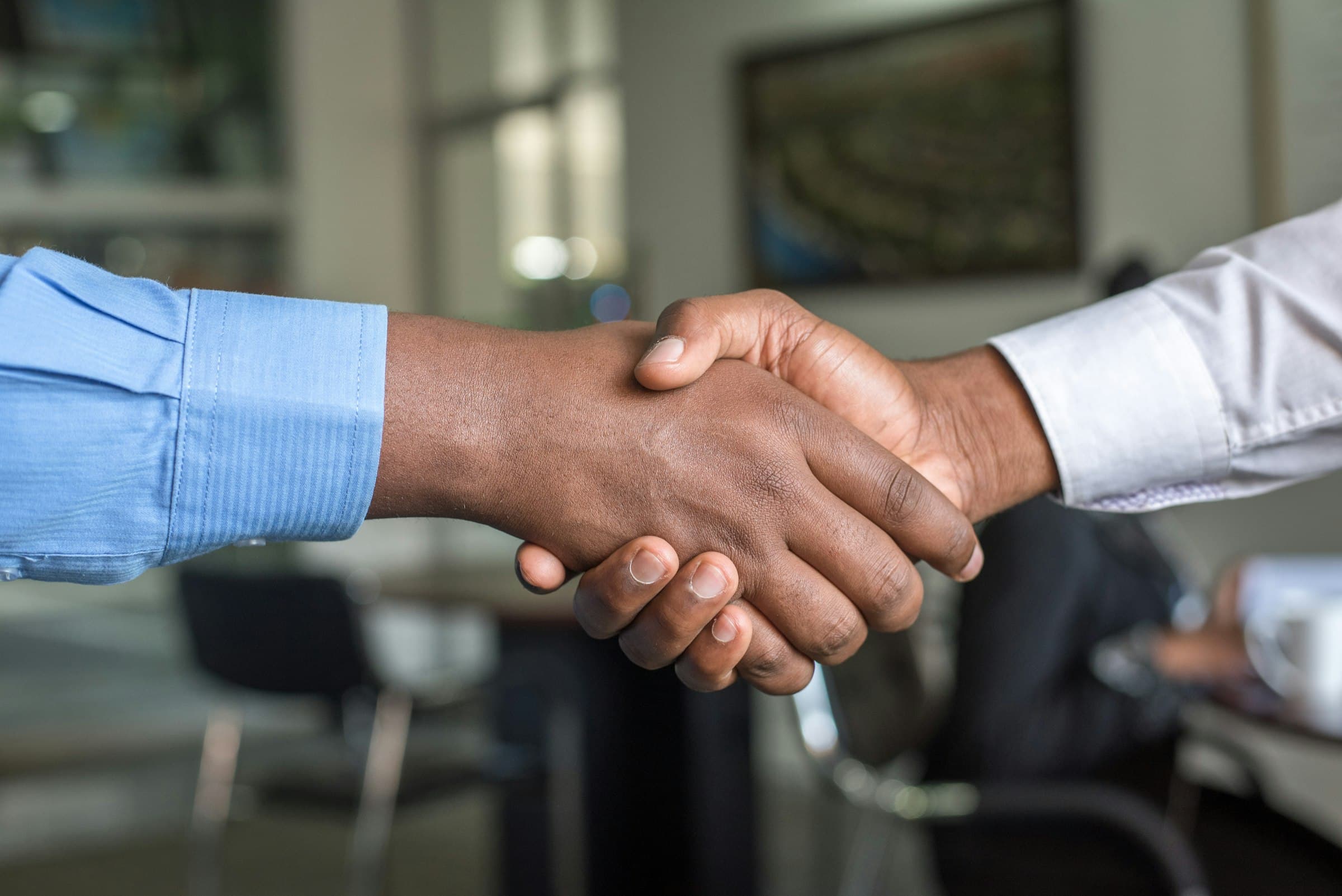 Professional handshake representing partnership with Lancer Elevators